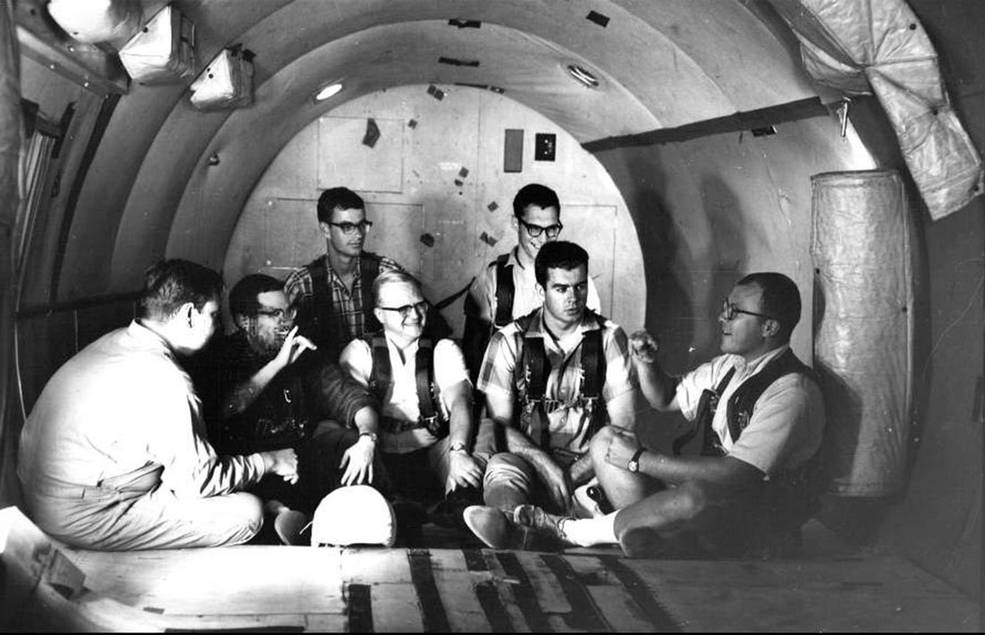 NASA Gallaudet research participants chat in sign language while sitting in a zero gravity aircraft before take-off. credit: U.S. Navy/Gallaudet University collection.