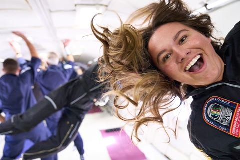 Mary Cooper, a white woman with a prosthetic leg, smiles broadly as her hair floats in zero-gravity onboard Mission: AstroAccess Flight One. Credit: ZERO-G