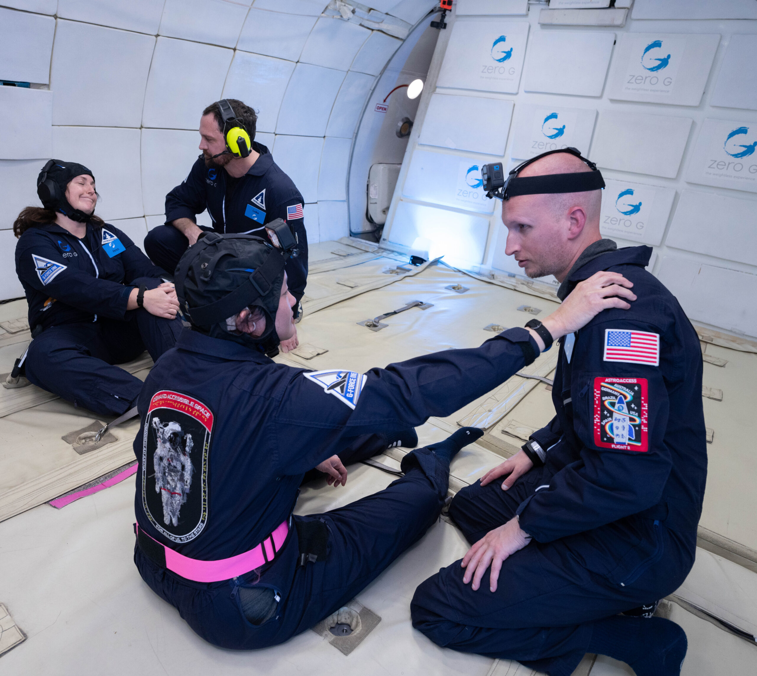 Four ambassadors test out light signaling devices to indicate changes in gravity (Image credit: AstroAccess/Zero G Corporation)